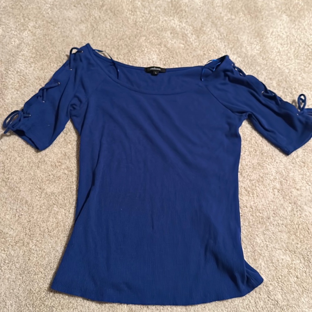blue women’s top with cross cross ties on sleeves